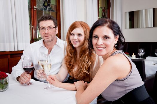 smiling happy people in restaurant drinking talking having fun 