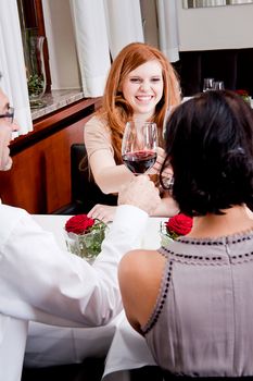 smiling happy people in restaurant drinking talking having fun 