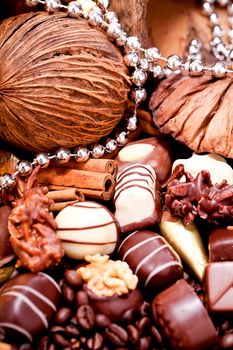 collection of different chocolate pralines truffels on golden brown background macro