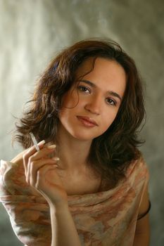 Portrait of the woman with a cigarette in studio
