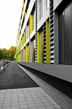 cladding on business building in grey, yellow and green