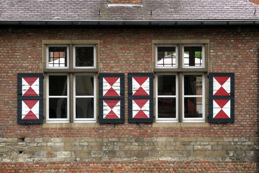 Red brick wall with two windows