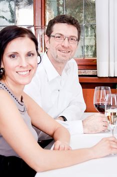 smiling happy people in restaurant drinking talking having fun 