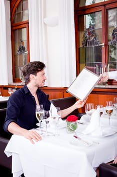 man and woman in restaurant waiter bring card and order food
