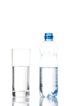 Bottle of water and glass. Isolated on white.