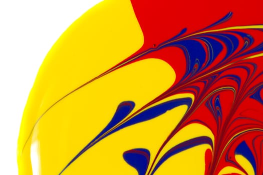 Abstract image of red, yellow, and blue paint swirls