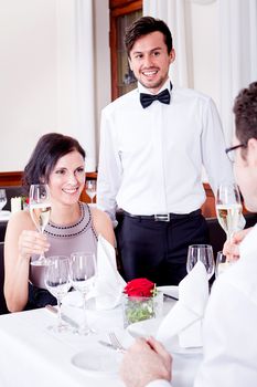 happy smiling couple in restaurant for dinner sitting talking drinking