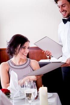 man and woman in restaurant waiter bring card and order food