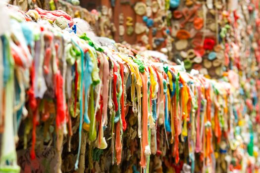 The photograph depicts the "Gum Wall" tourist attraction in Seattle, Washington.  The "Gum Wall" is an alleyway where for years visitors have stuck chewing gum on the brick walls, windowsills, doorways, etc.