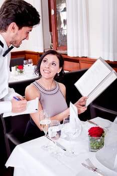man and woman in restaurant waiter bring card and order food