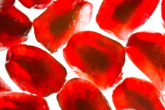Close-up image of pomegranate seeds on a white background
