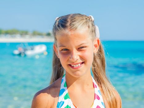 Portrait of cute happy girl on the beach