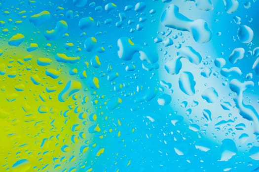 Water droplets on a blue and green background