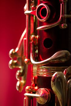 Close-up of a soprano clarinet on a red background