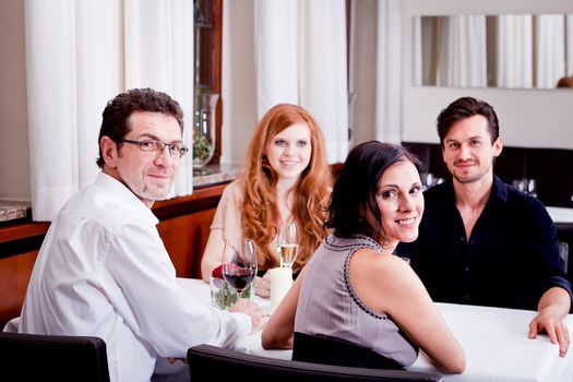 smiling happy people in restaurant drinking talking having fun 