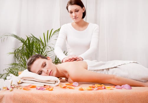 young attractive smilig woman doing wellness spa relaxing massage