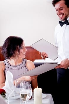 man and woman in restaurant waiter bring card and order food