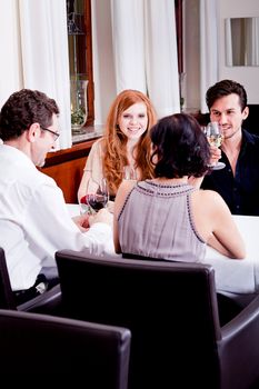 smiling happy people in restaurant drinking talking having fun 