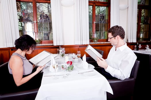 man and woman in restaurant waiter bring card and order food