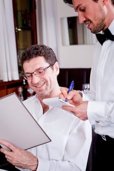 man and woman in restaurant waiter bring card and order food