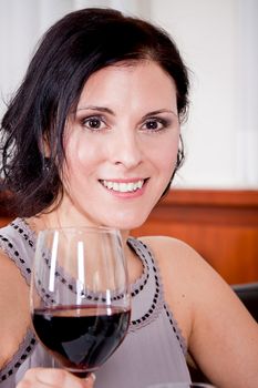 man and woman in restaurant for dinner drinking red wine and smiling