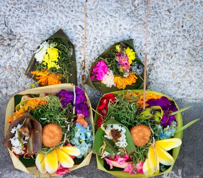 Offerings to gods in Bali with flowers, food and aroma sticks