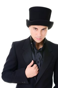 Serious strict man illusionist in black suit and high top hat isolated on white background