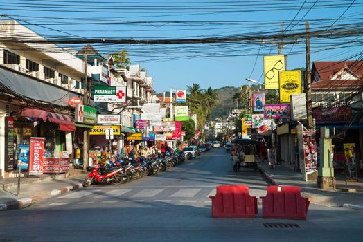 PHUKET, THAILAND - Jan 28: Patong ordinary street with shops, agencies and banners on Jan 28, 2013 in Phuket, Thailand. Phuket is a famous destination for thousands of tourists.