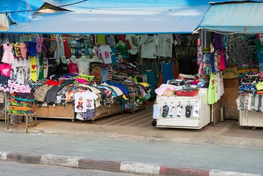 PHUKET, THAILAND - Jan 28: Patong ordinary common street open shop with clothes on Jan 28, 2013 in Phuket, Thailand. Phuket is a famous destination for thousands of tourists.