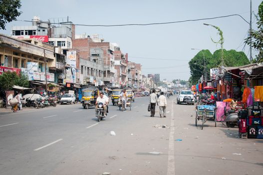 AMRITSAR, INDIA - AUG 28: Motorbikes and tuk tuk traffic on wide messy Indian street on Aug 28, 2011 in Amritsar, India. Bikes is the common individual transport in India