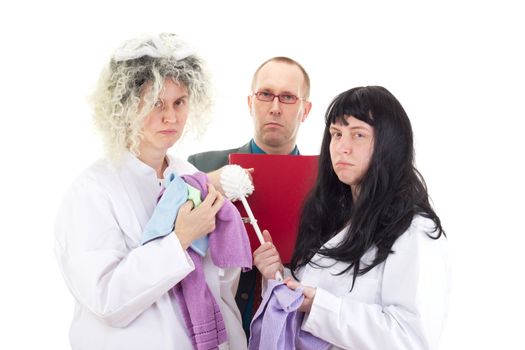 Female cleaners in white work coats with supervisor