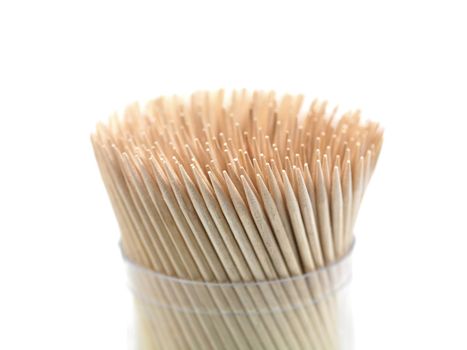 A close up shot of a wooden toothpicks on white