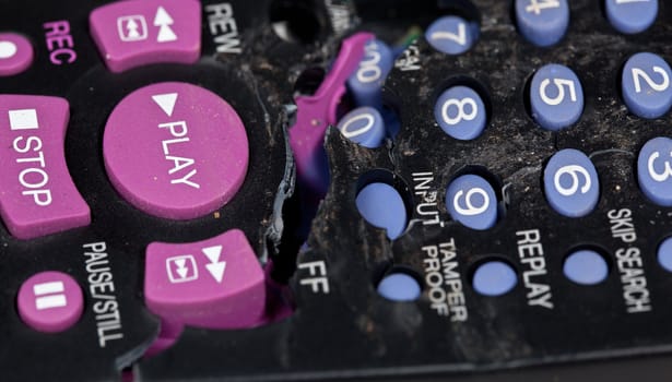 Broken remote control with focus on play button
