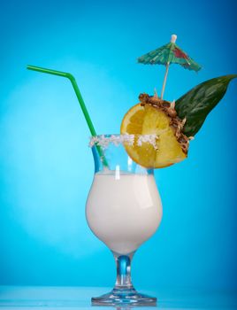 Pina Colada - Cocktail with Cream, Pineapple Juice and Rum on blue background