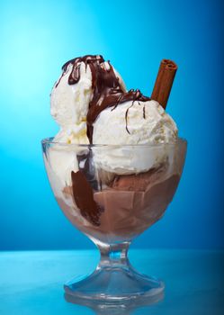 ice cream with chocolate sauce. closeup .on blue background.