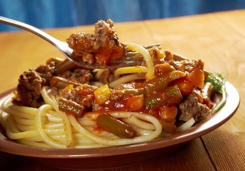  pasta with  beef ,vegetable  tomato sauce  on wooden table