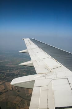 Earth and wing of an airplane flying