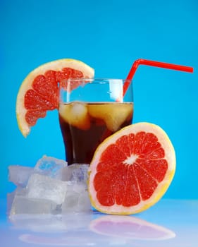 tropical red cold cocktail  closeup on blue background.