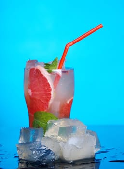 Mojito grapefruit  cocktail.on blue background. close up