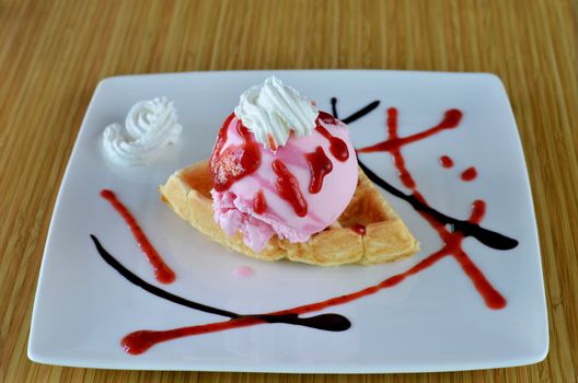 Waffle and whipping cream with strawberry ice cream