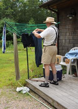 Country gentleman washing his clothes at his rural home.