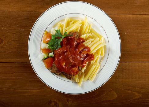  pasta with tomato beef sauce  on wooden table