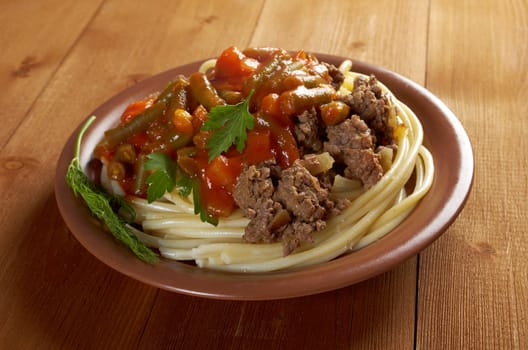  pasta with  beef ,vegetable  tomato sauce  on wooden table