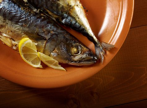 Mackerel on a grill. Fish prepared  with a lemon
