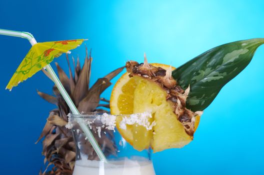 Pina Colada - Cocktail with Cream, Pineapple Juice and Rum on blue background