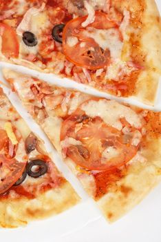 meat pizza closeup with carbonado ham, tomato, olive and mozzarella cheese