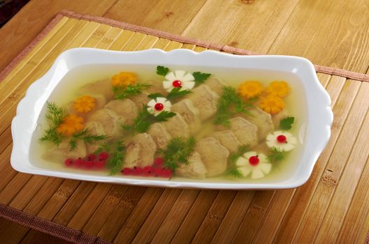 Aspic from meat decorated with egg, carrot,