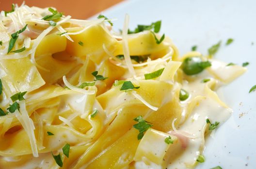 pasta Fettuccine Alfredo with cherry tomato, ham. close-up