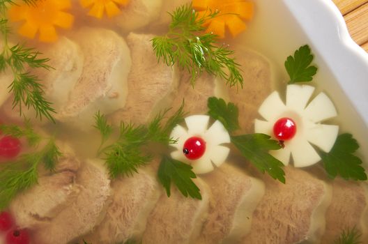Aspic from meat decorated with egg, carrot,