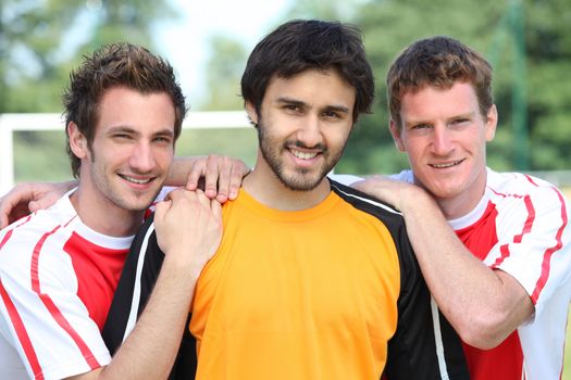 portrait of 3 football players